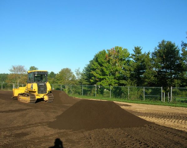 spreading athletic field mix